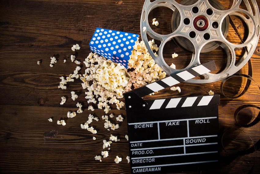 Hollywood theme party: Cinema concept of vintage film reel with popcorn