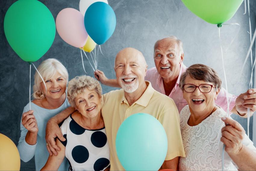 congratulations on your retirement: group of happy retired people holding balloons