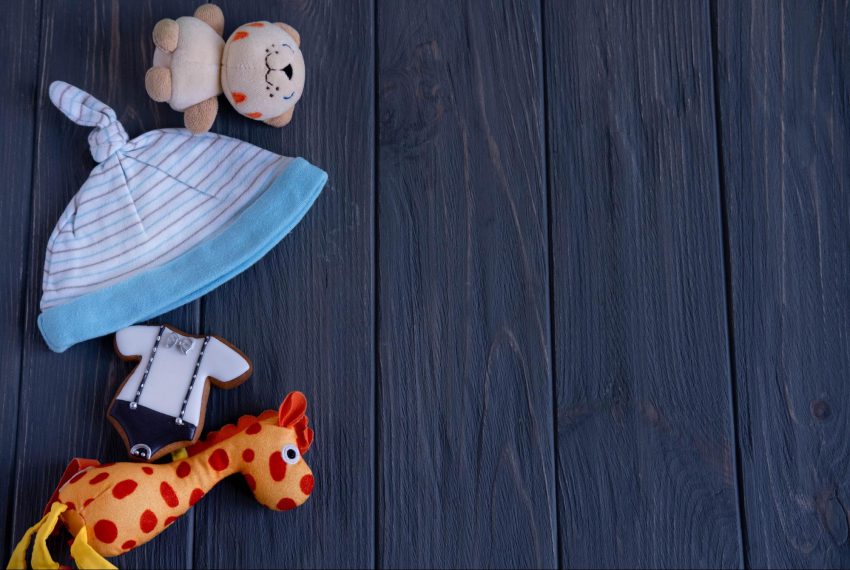 virtual baby shower invitation wording: two stuffed toys and a baby hat