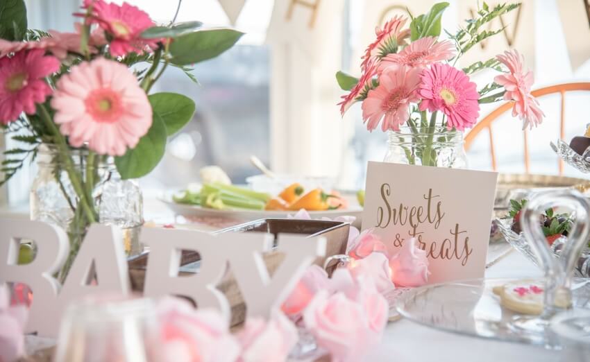 Baby in bloom baby shower: jars with flowers and baby shower decorations on a table