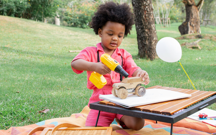Kid using a toy drill