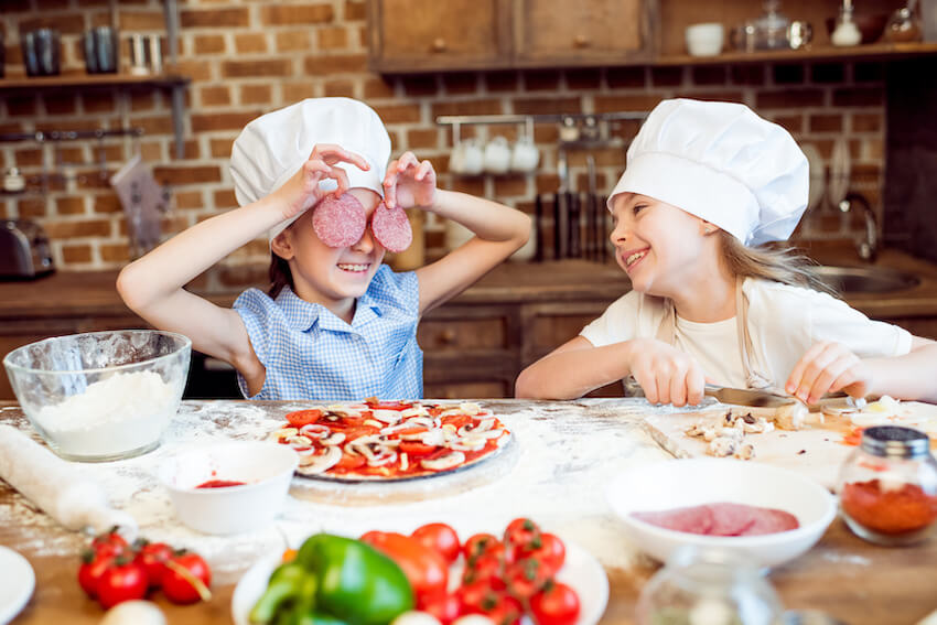 Kids baking a pizza