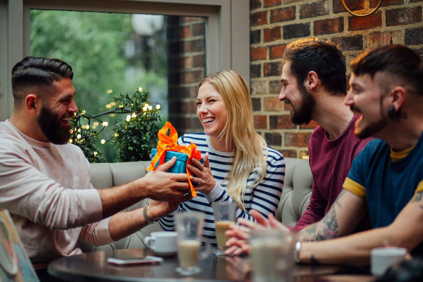 Milestone birthday: man giving a birthday gift to his friend