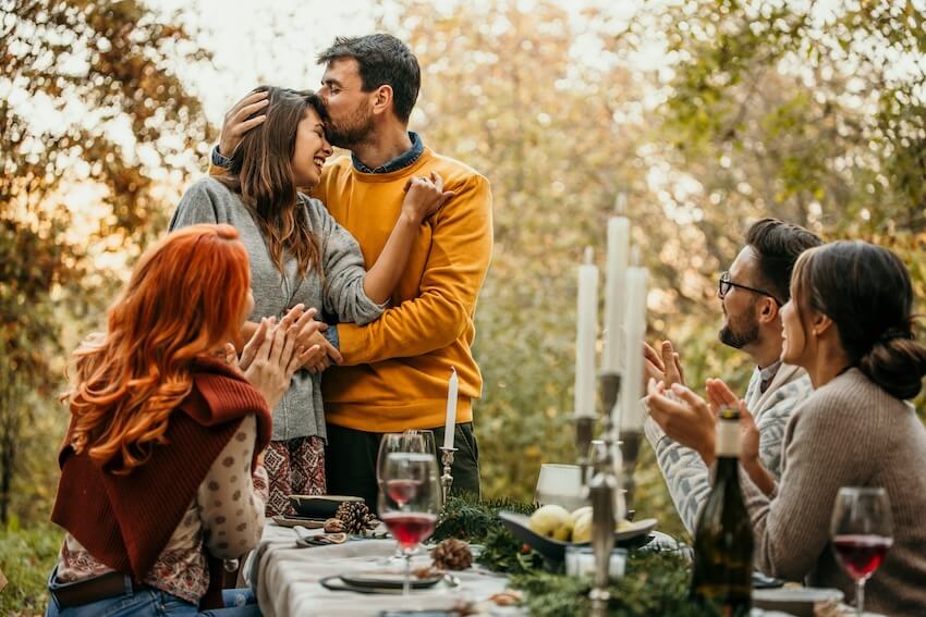 Engagement decorations: man kissing his fiancé on the forehead