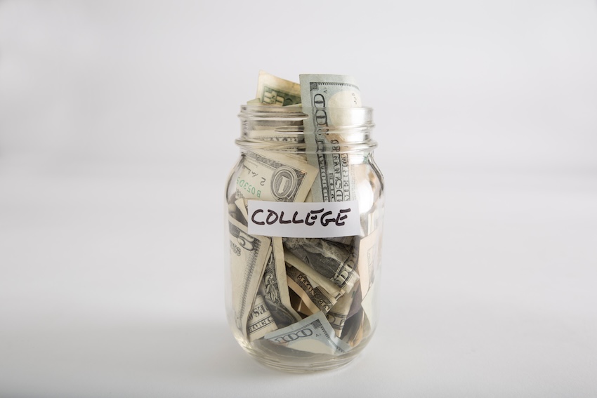 Mason jar filled with money, labeled with the word "COLLEGE"