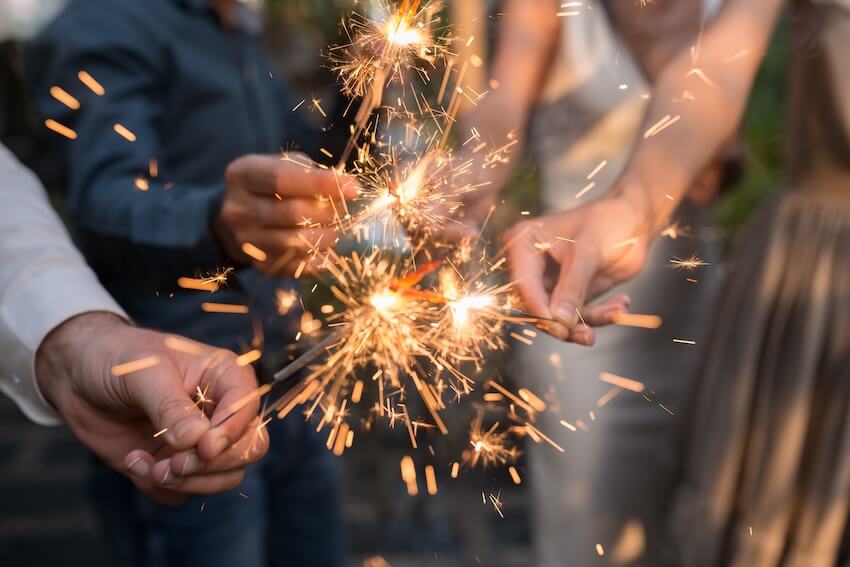 Questions to ask wedding venue: people holding sparklers