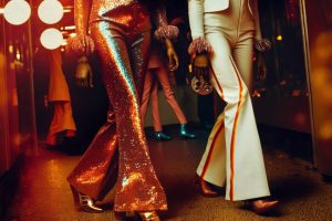 People wearing 70s theme party outfits