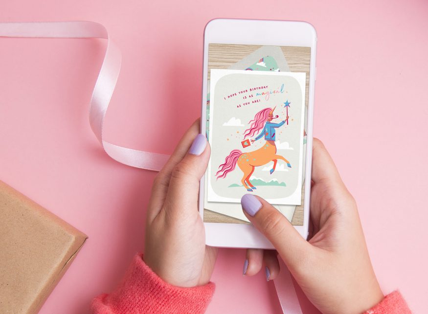 electronic birthday cards: person looking at a birthday invite on their phone