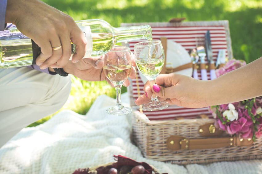 Person pouring wine into a wine glass
