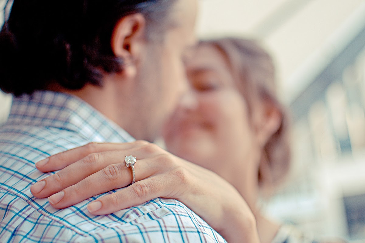 An older couple dances with the woman's hand on the man's shoulder, showing a diamond ring