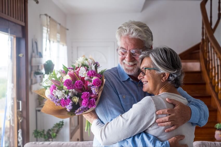 50th wedding anniversary gifts: senior couple happily dancing at home