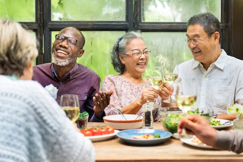Retirement party: senior friends eating at a restaurant