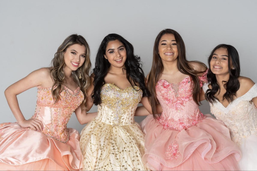 quinceanera gifts: Group of girls wearing gowns and smiling at the camera