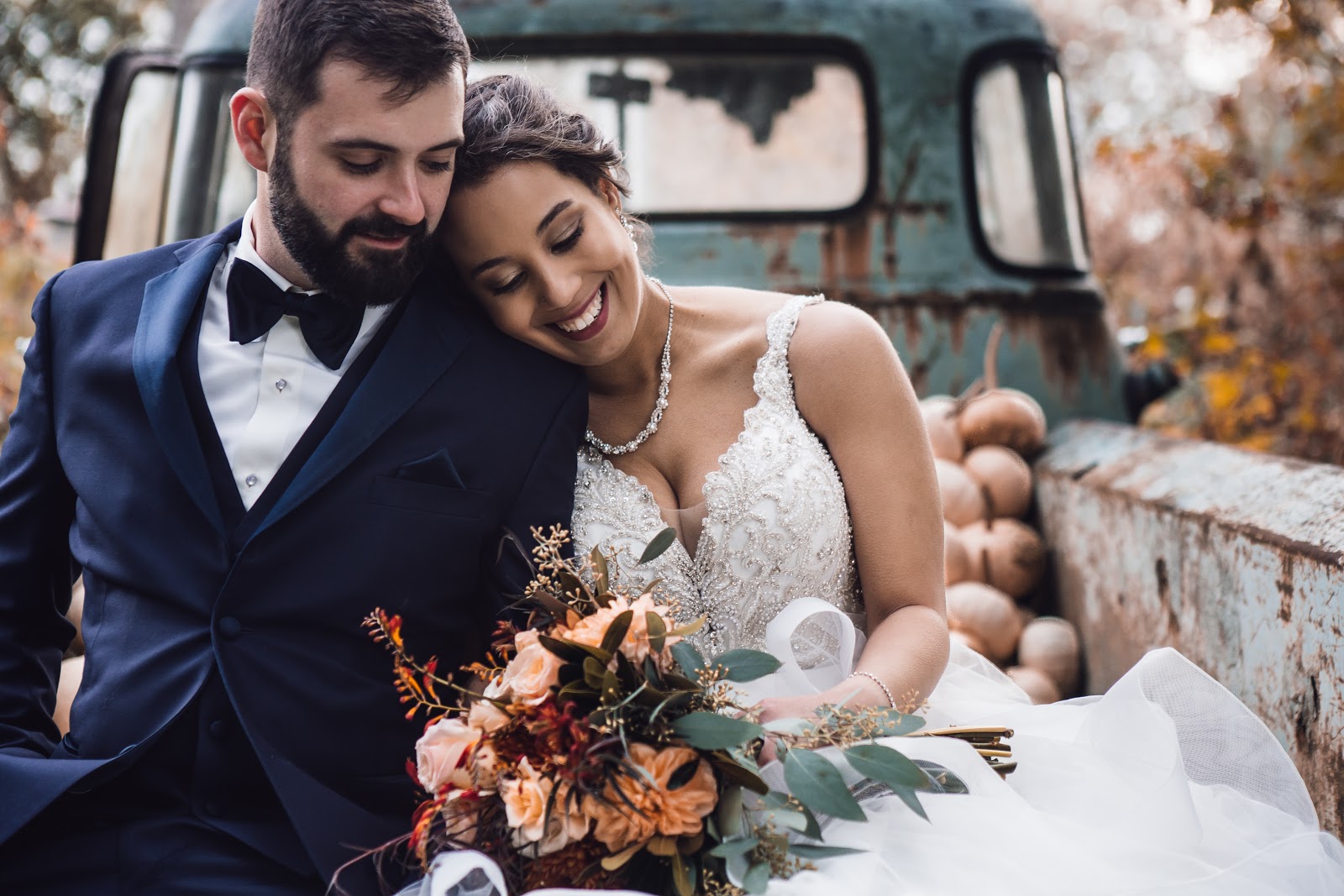 When to send save the dates: a bride and groom in the back of an antique truck