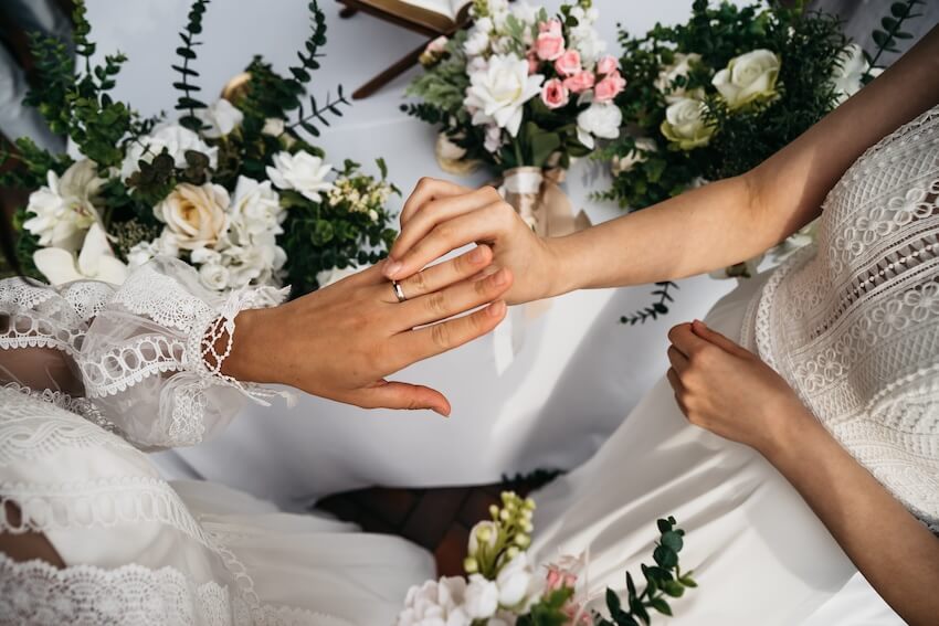 Wedding ceremony ideas: two brides exchanging rings at their wedding