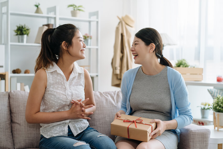Will you be my bridesmaid: two women happily talking to each other at home