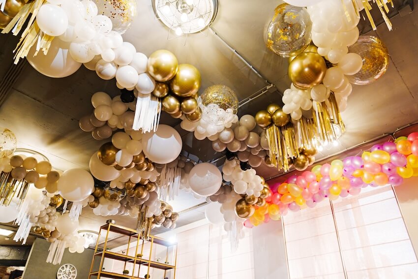 Golden birthday ideas for girl: white and gold balloon ceiling decoration
