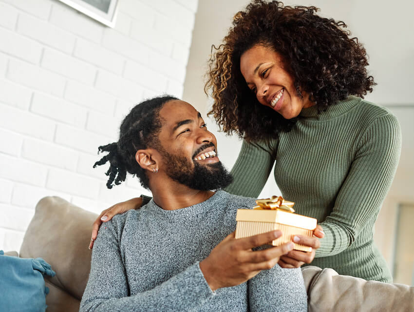 50 and fabulous: wife giving a gift to her husband