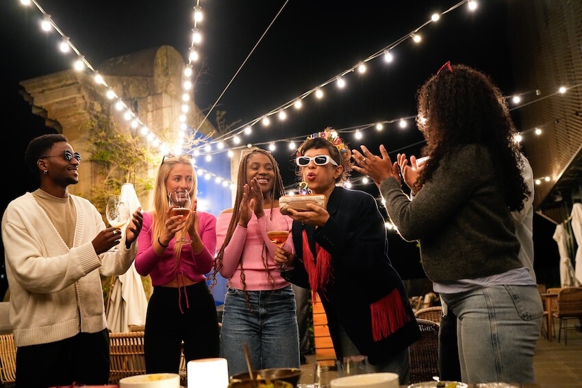 25th birthday ideas: woman celebrating her birthday with family and friends