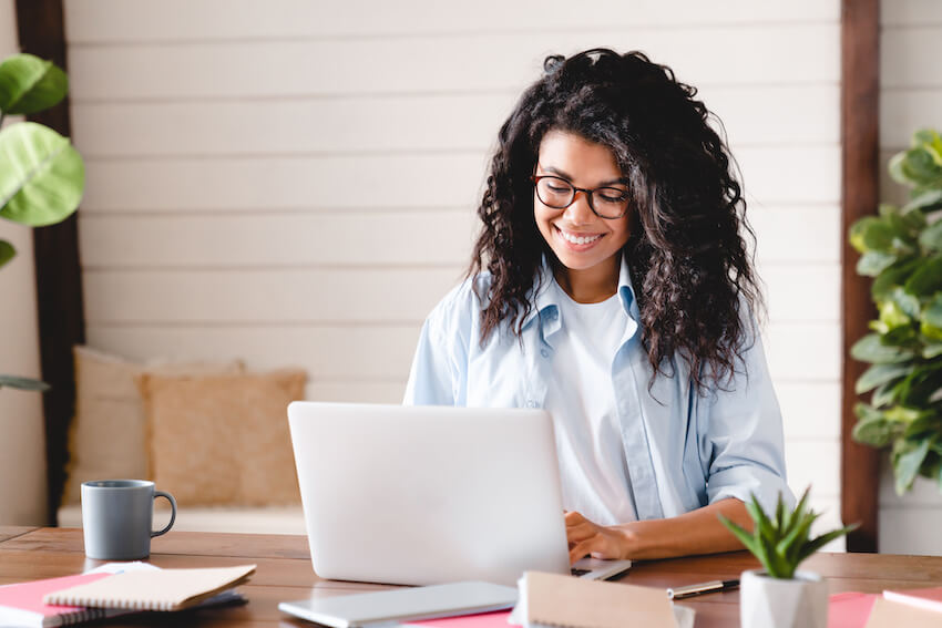 Woman happily using her laptop