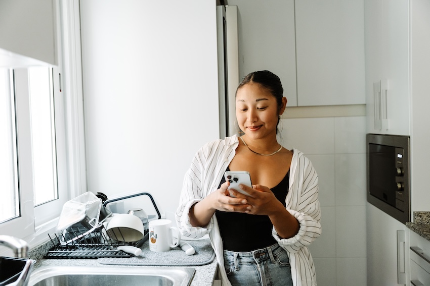Digital thank you card: woman happily using her phone at home