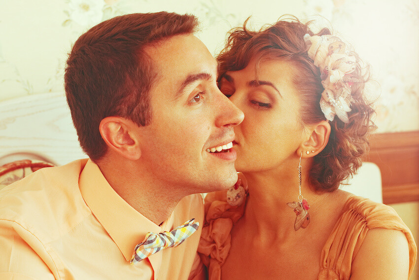 Woman kissing her partner