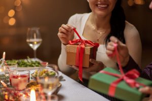 New Year's traditions: woman opening a gift