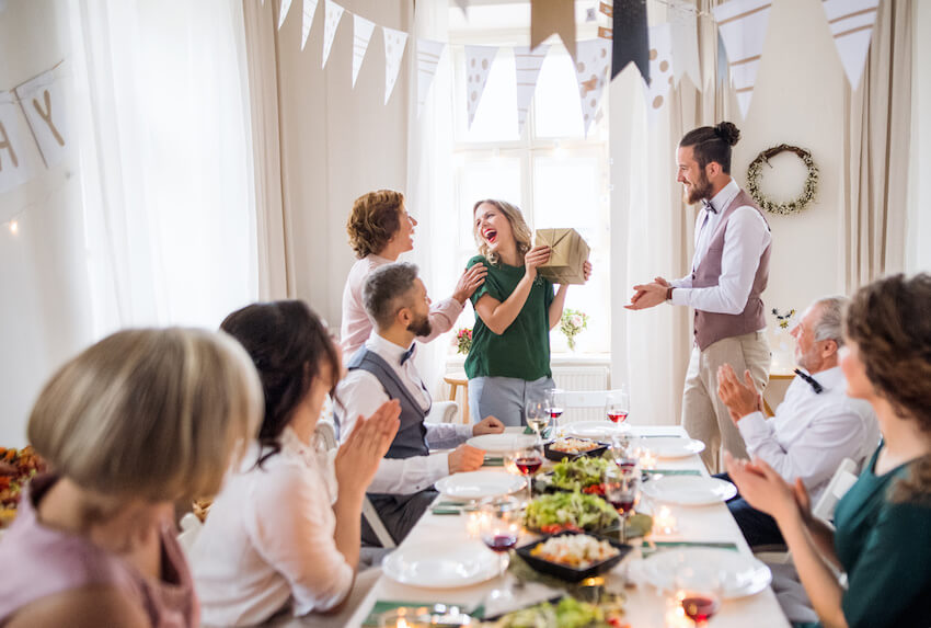 How to plan a birthday party: woman receiving a gift from a senior woman