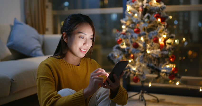 Woman using her phone at home