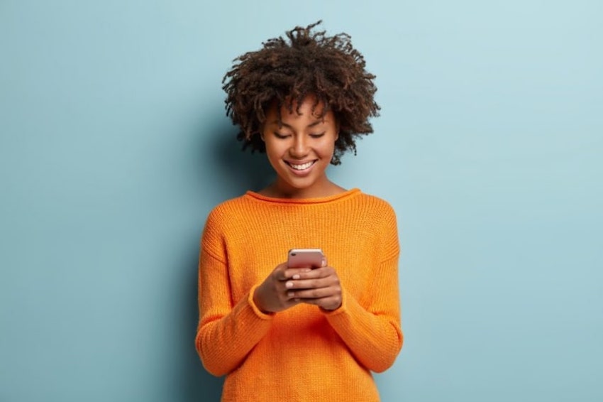 Text message invitations: woman using her phone