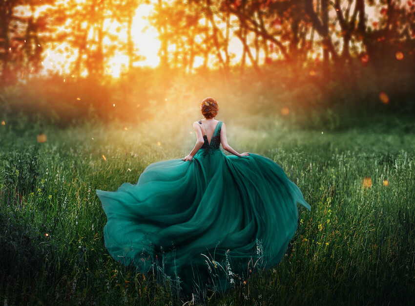 Woman in a gown, running into a forest