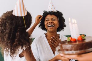 Funny birthday wishes for girls: women happily wearing party hats