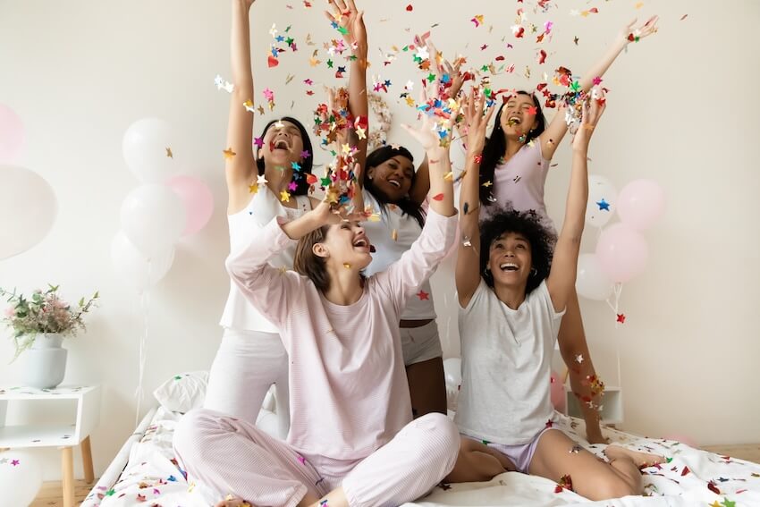 Women throwing confetti up into the air